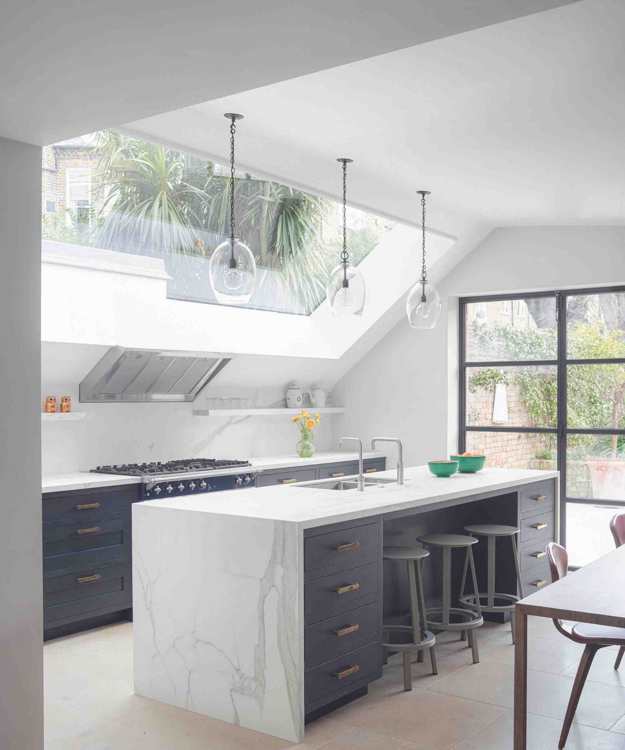 A kitchen with upper glazing and tall windows, illustrating the different glass areas and access considerations in the source window-care guide.