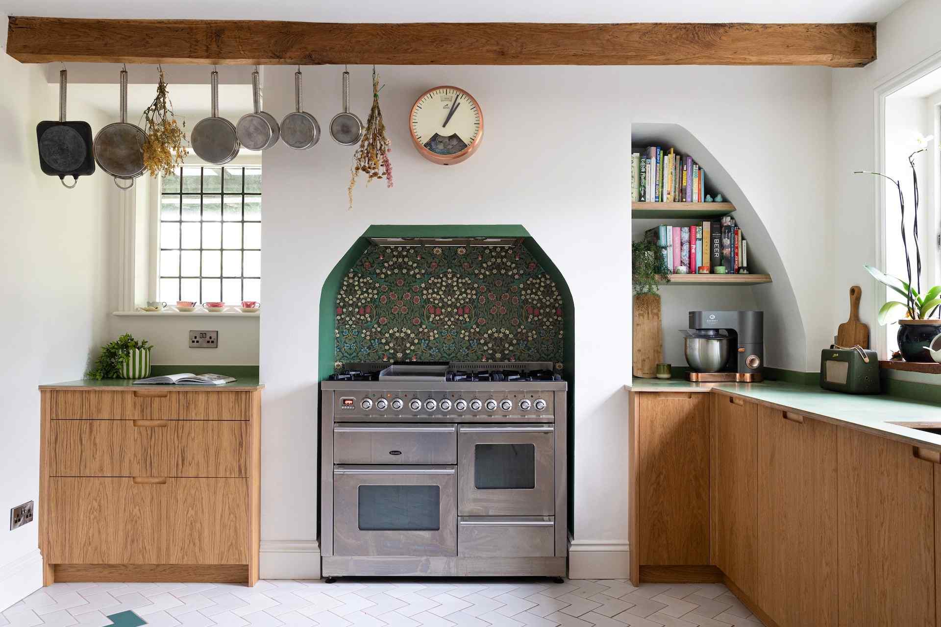 Wooden lower kitchen cabinets around a range cooker, with panels and edges that require finish-compatible cleaning.