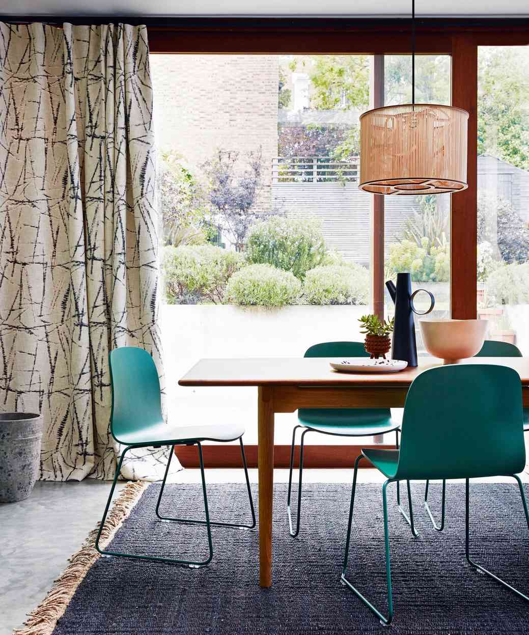 Curtains beside large dining-area glazing, illustrating the window treatments included in the source frame-before-glass cleaning sequence.
