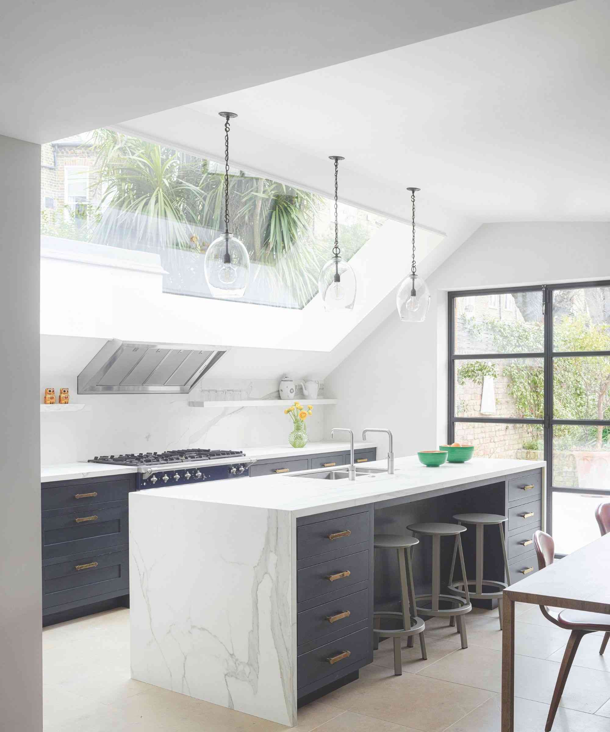 A kitchen with dark cabinetry and pale veined counters, used as a marble-care illustration in the source; it is not presented as Martha Stewart's reported counter.