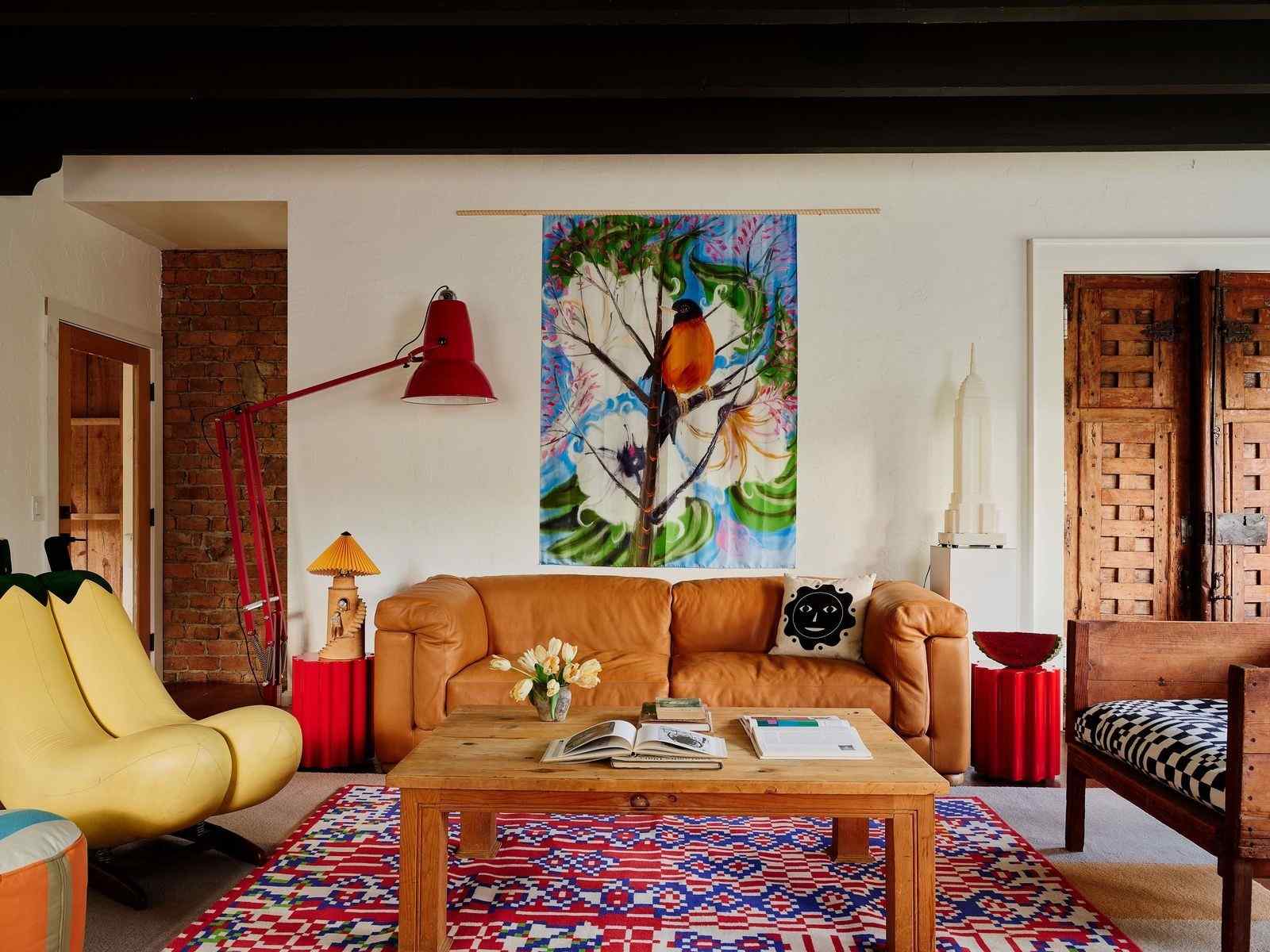 A living room with a tan sofa and colorful furnishings, used as a sofa-care illustration in the source guide.