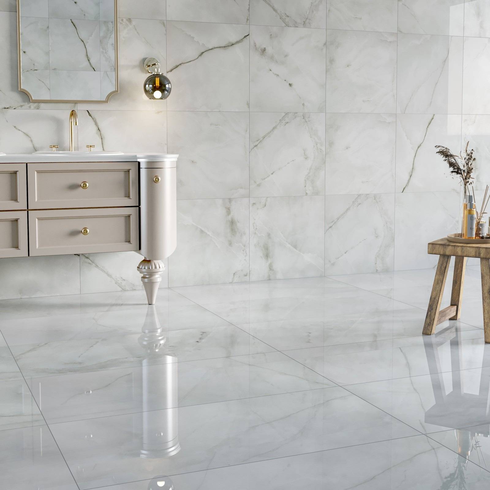 A bathroom with pale veined polished tiles reflecting the vanity and nearby furnishings, illustrating the surface discussed in the source.